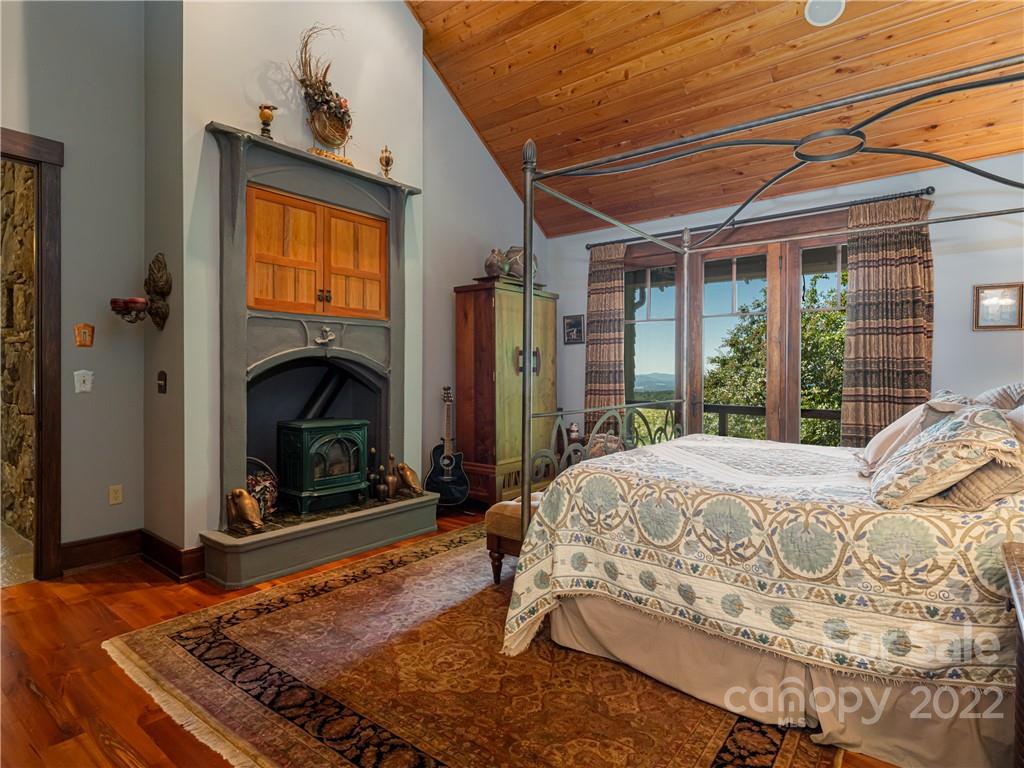 168 Pinkerton Corner Fairview, NC 28730 - Photo 20 of 48 a bed sitting in a spacious bedroom next to a window