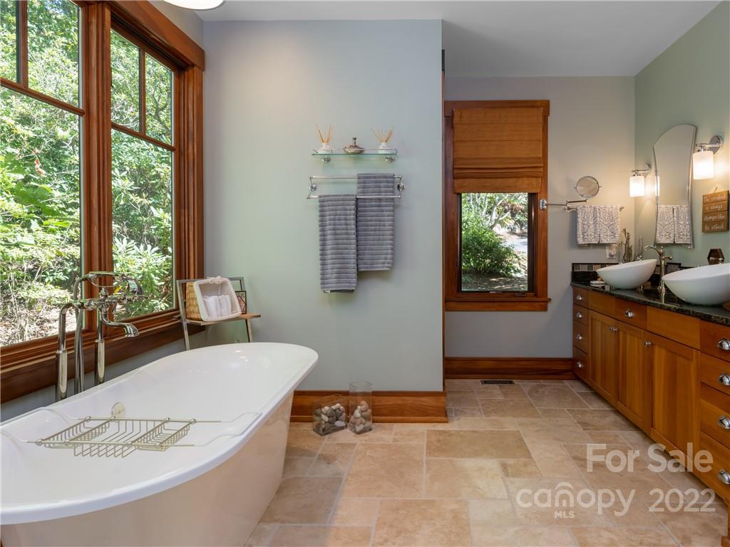 168 Pinkerton Corner Fairview, NC 28730 - Photo 22 of 48 a bathroom with a tub sink and mirror