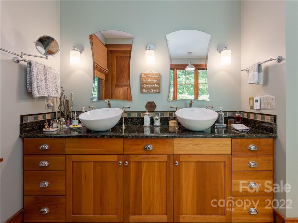 168 Pinkerton Corner Fairview, NC 28730 - Photo 23 of 48 a bathroom with a granite countertop sink a mirror and