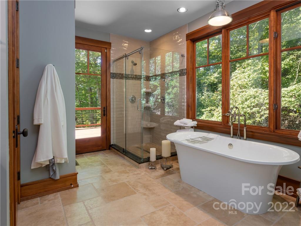 168 Pinkerton Corner Fairview, NC 28730 - Photo 24 of 48 a spacious bathroom with a tub and shower