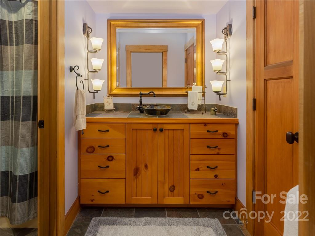 168 Pinkerton Corner Fairview, NC 28730 - Photo 37 of 48 a bathroom with a granite countertop sink and a mirror