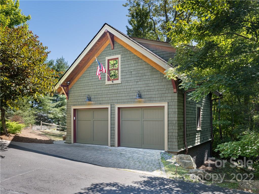 168 Pinkerton Corner Fairview, NC 28730 - Photo 45 of 48 a front view of a house with a yard and garage