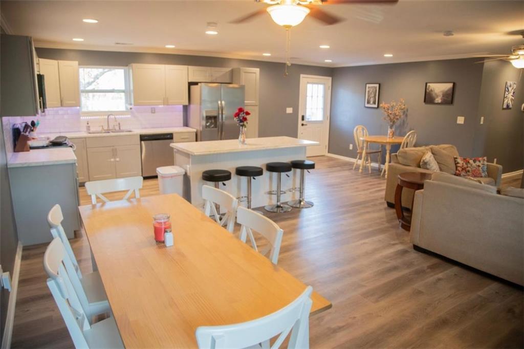 571 Oak Grove Road McDonough, GA 30253 - Photo 11 of 31 a living room with furniture a wooden floor and a kitchen view