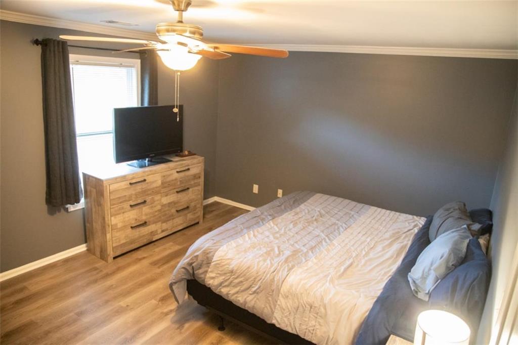 571 Oak Grove Road McDonough, GA 30253 - Photo 15 of 31 a bedroom with a bed and a flat tv screen on a dresser