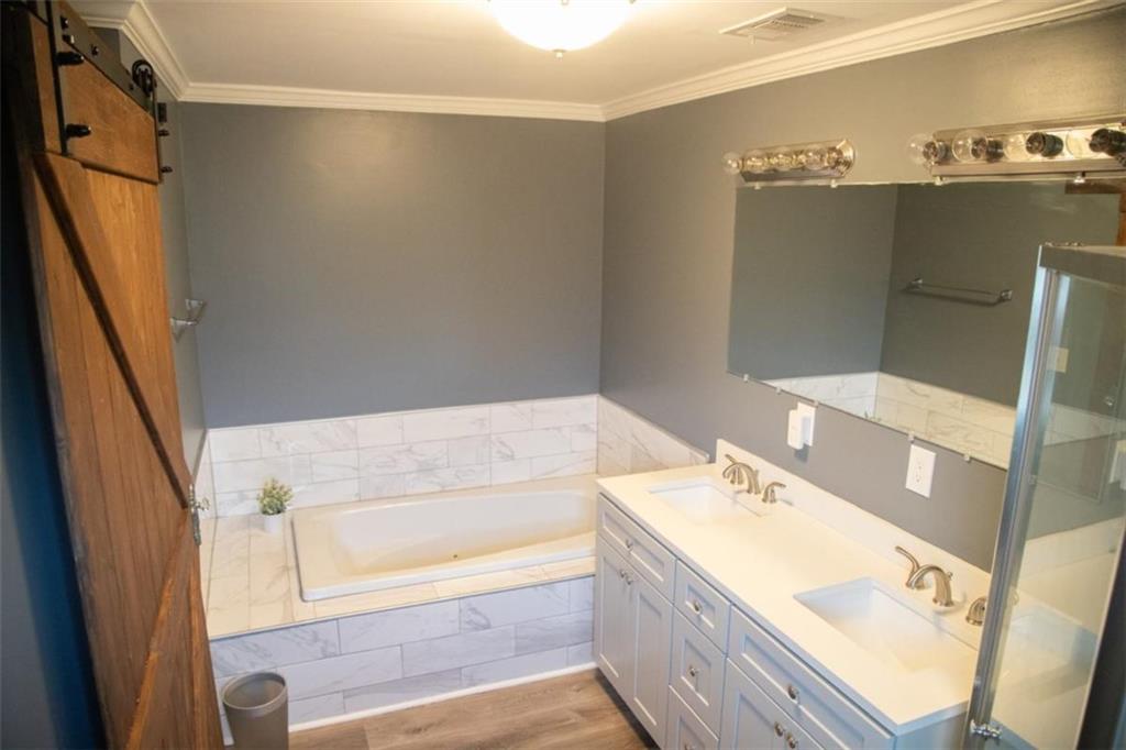 571 Oak Grove Road McDonough, GA 30253 - Photo 20 of 31 a bathroom with a tub sink and mirror