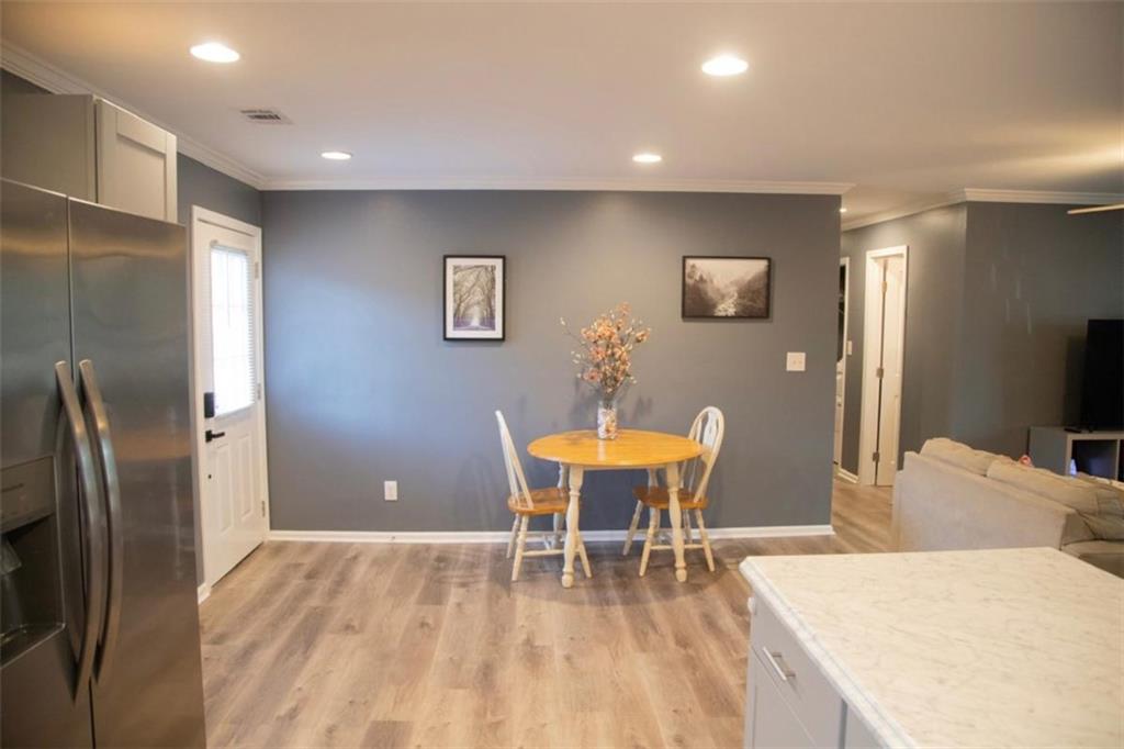 571 Oak Grove Road McDonough, GA 30253 - Photo 7 of 31 a view of a dining room with furniture and wooden floor