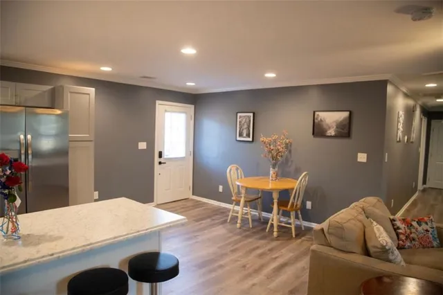 a kitchen with stainless steel appliances a stove a sink a microwave and a refrigerator