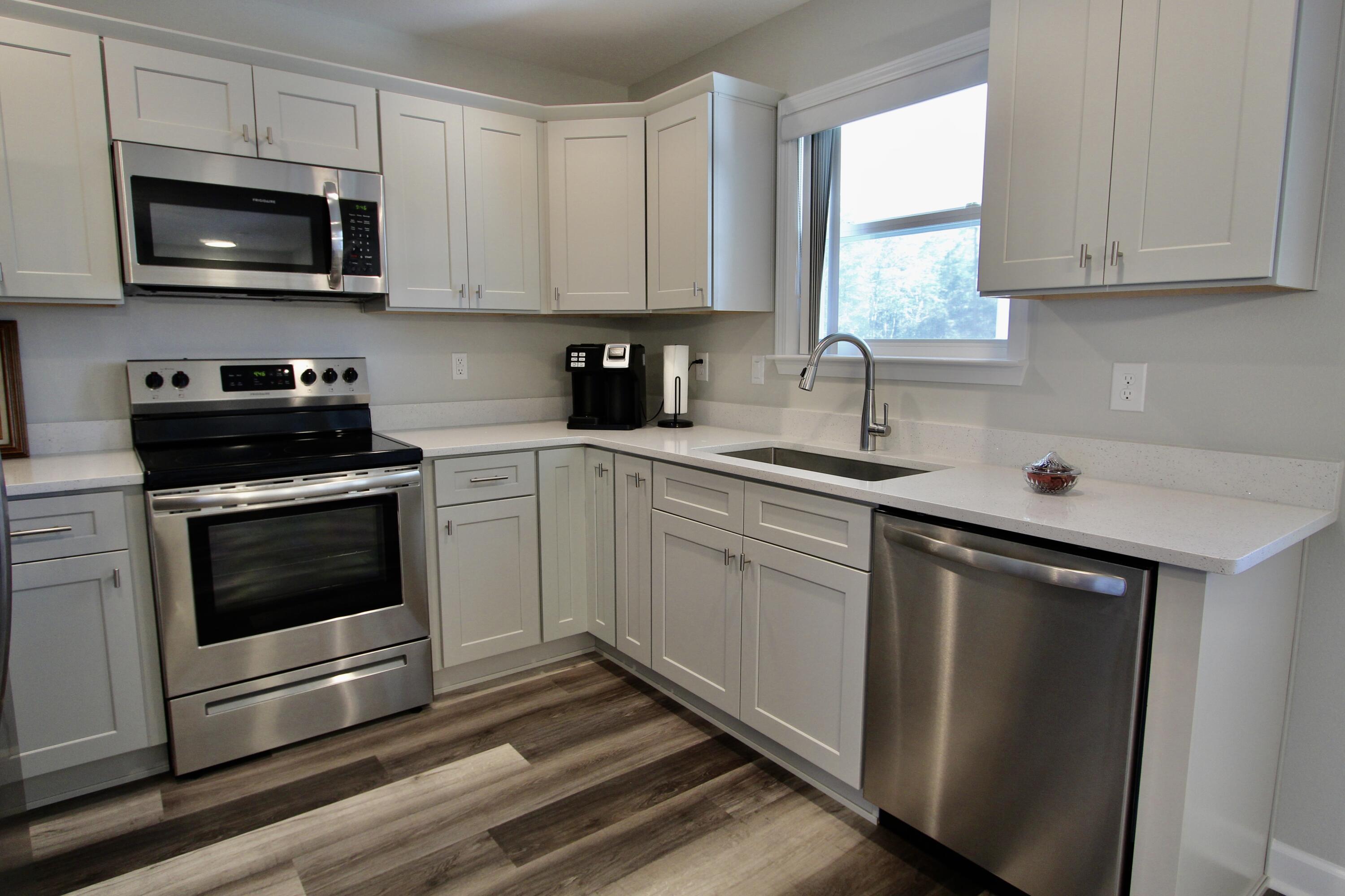 6447 Georgia Avenue Crestview, FL 32539 - Photo 15 of 36 a kitchen with cabinets stainless steel appliances a sink and a window