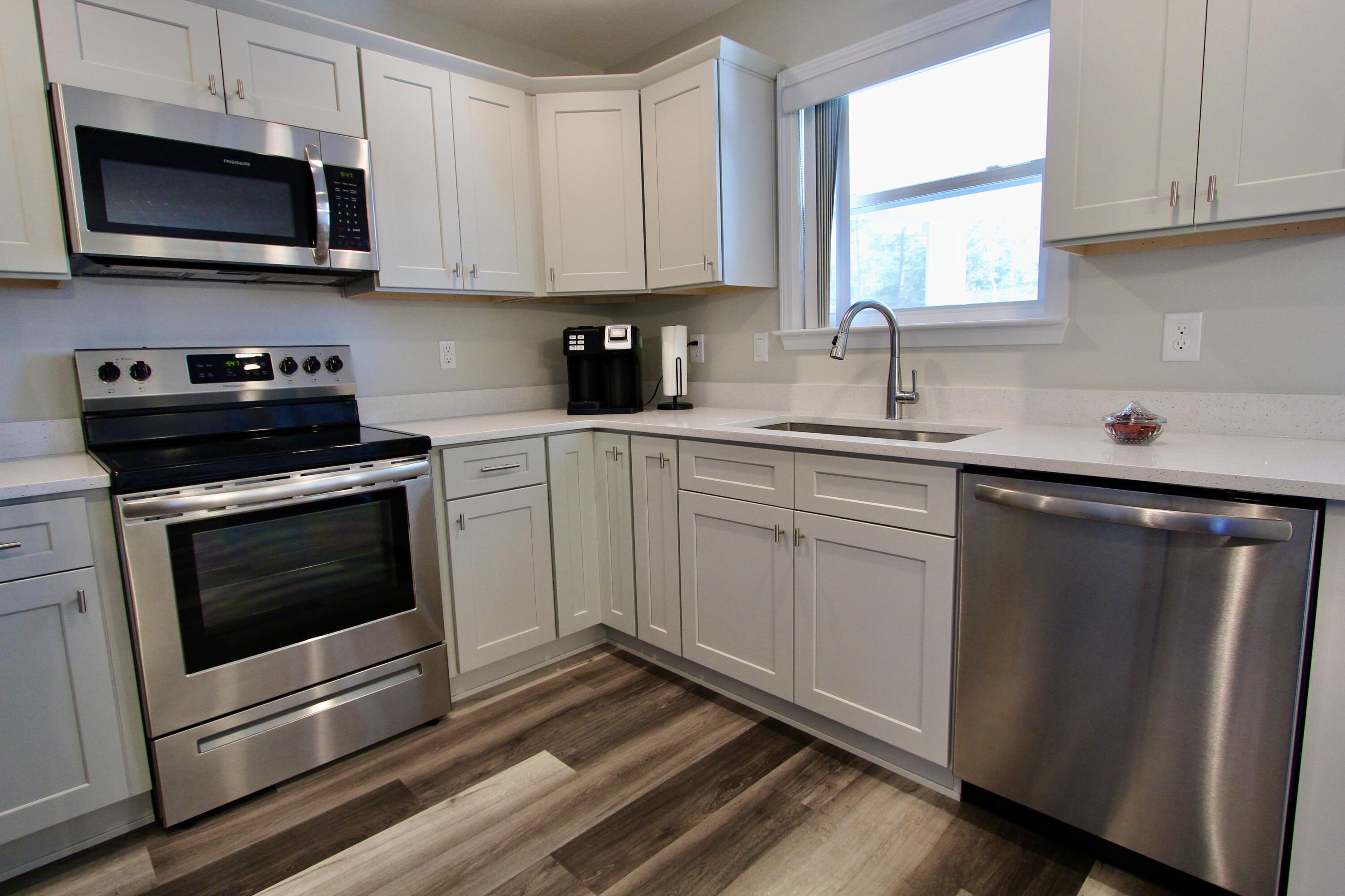 6447 Georgia Avenue Crestview, FL 32539 - Photo 16 of 36 a kitchen with stainless steel appliances a sink a stove and microwave