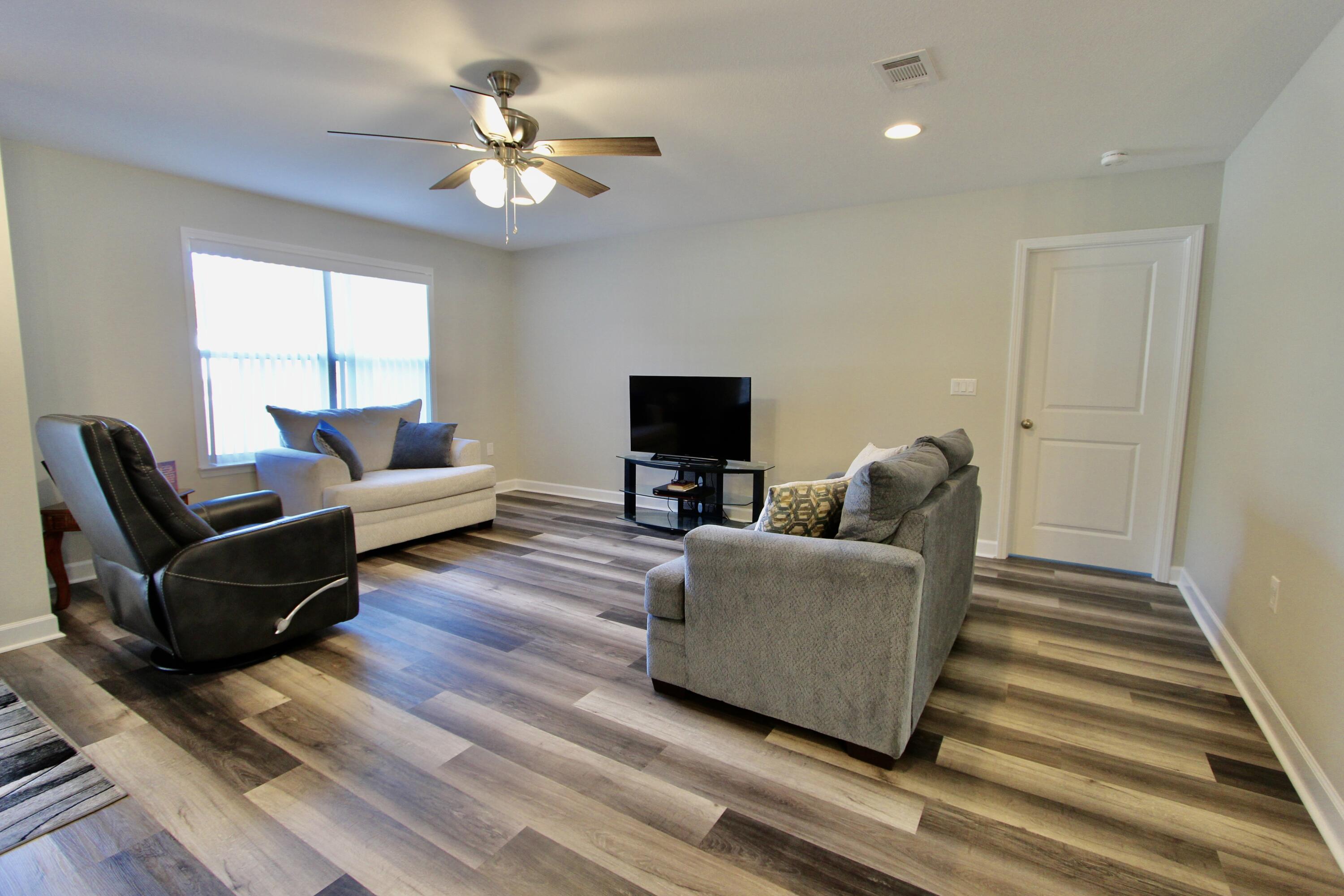 6447 Georgia Avenue Crestview, FL 32539 - Photo 18 of 36 a living room with furniture and a flat screen tv