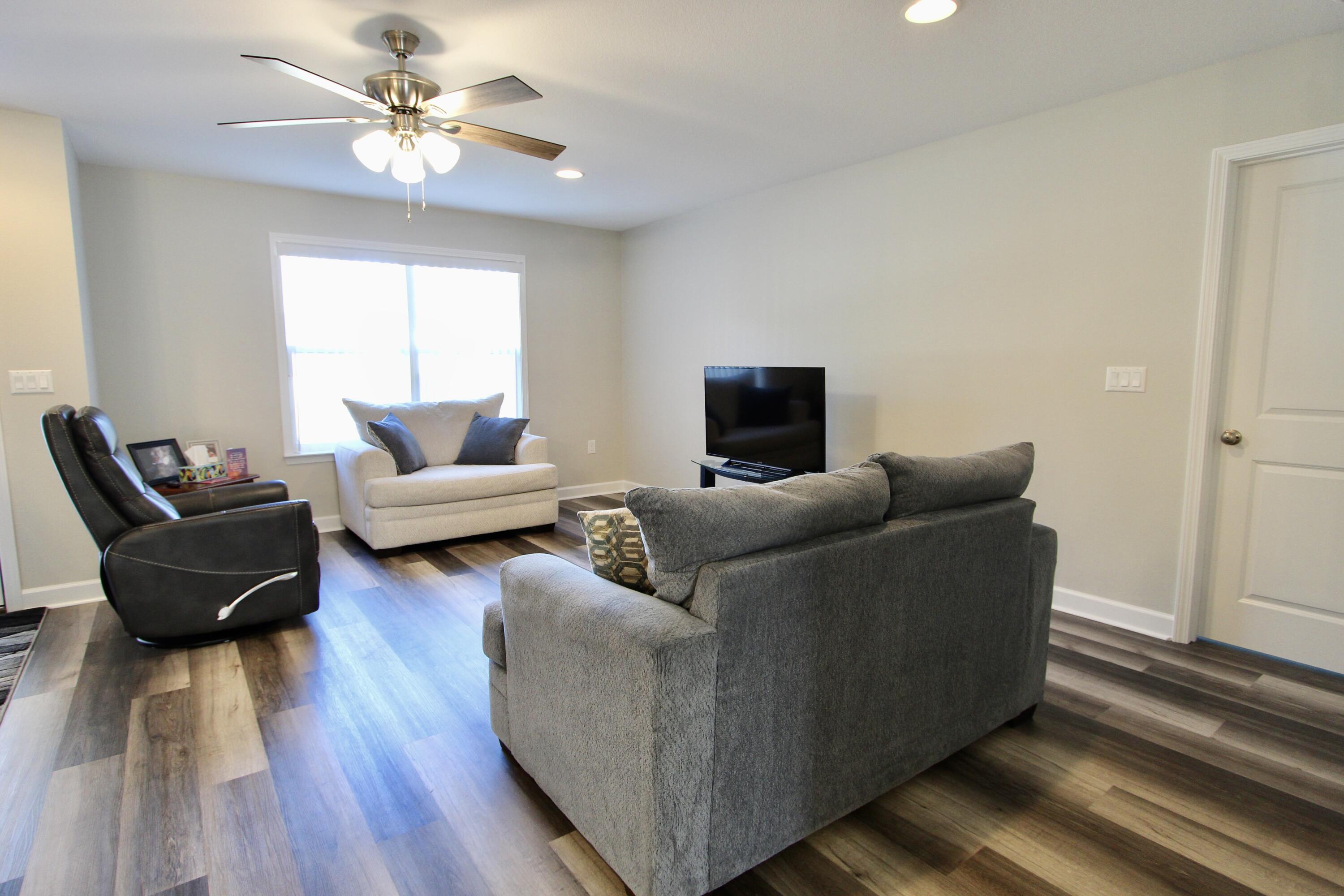 6447 Georgia Avenue Crestview, FL 32539 - Photo 19 of 36 a living room with furniture and a wooden floor