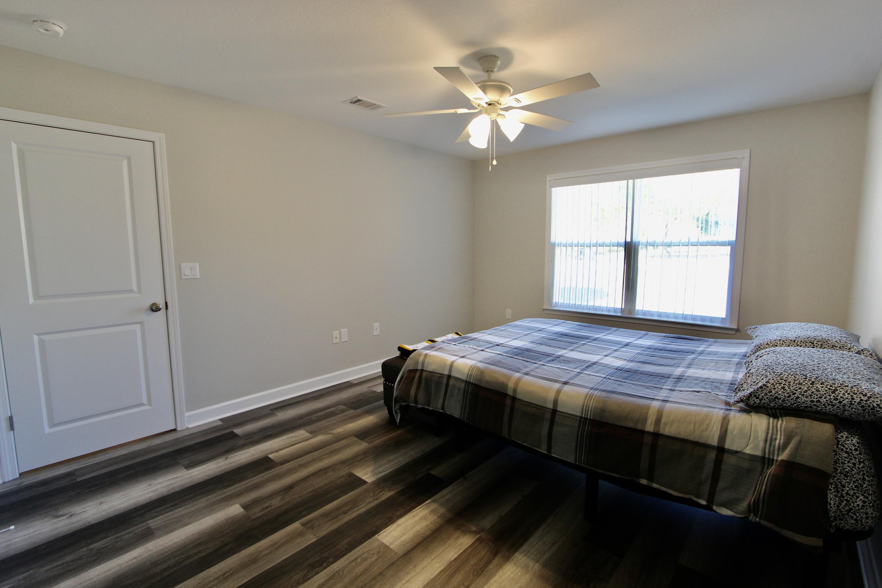 6447 Georgia Avenue Crestview, FL 32539 - Photo 21 of 36 a bedroom with a bed and window