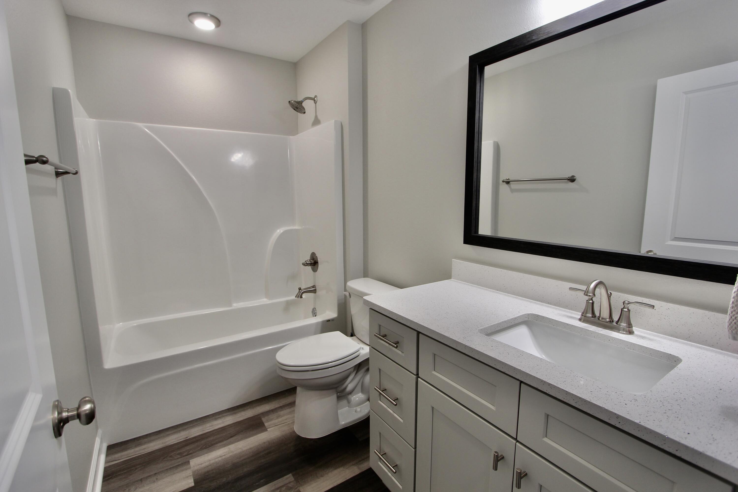6447 Georgia Avenue Crestview, FL 32539 - Photo 26 of 36 a bathroom with a sink toilet a mirror and shower