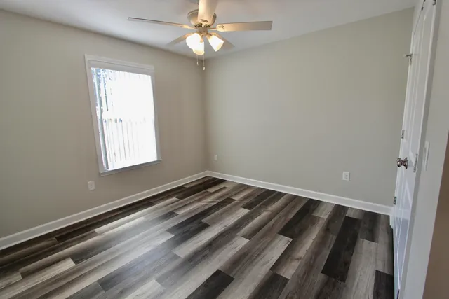 a view of a balcony with floor to ceiling windows with wooden floor
