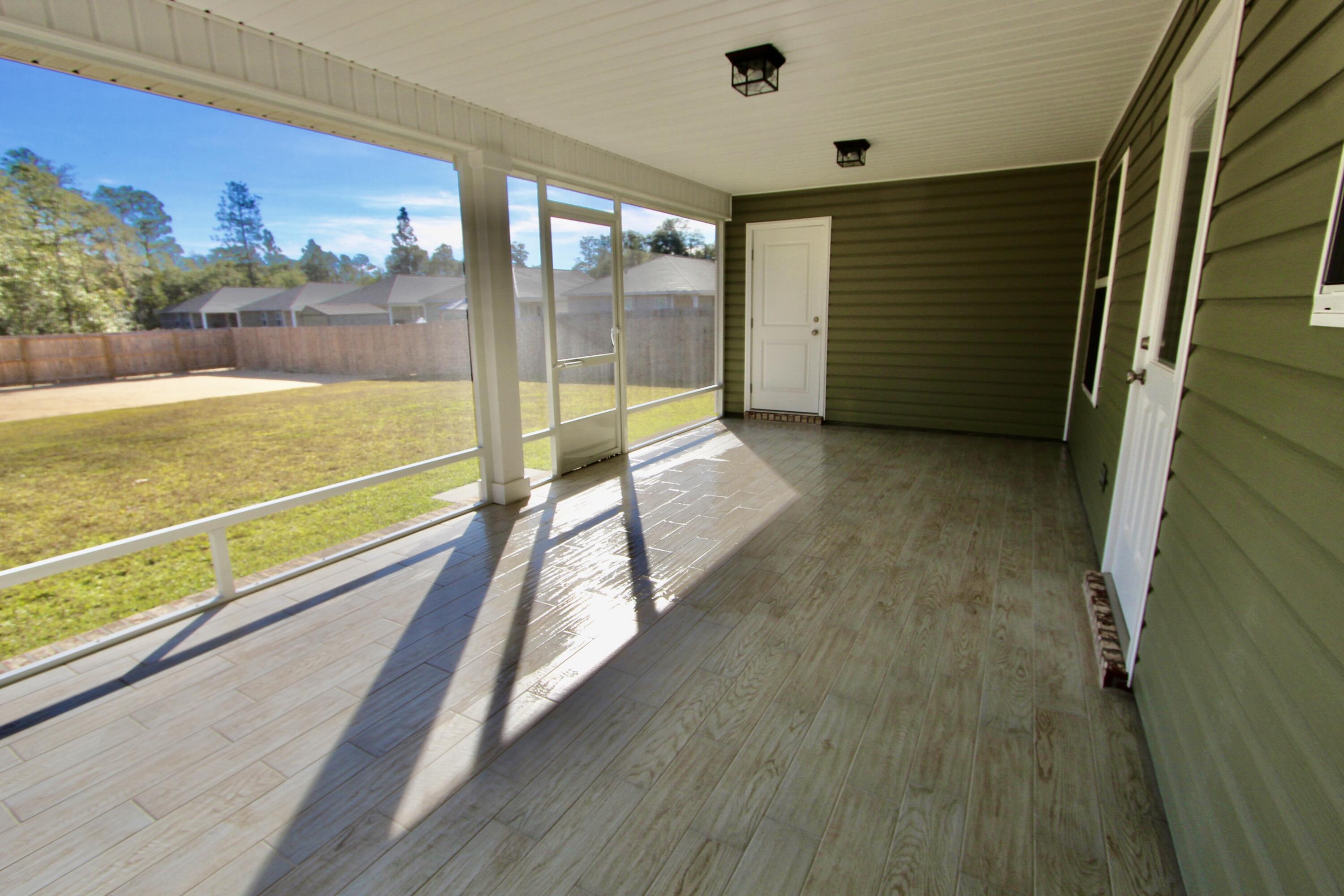 6447 Georgia Avenue Crestview, FL 32539 - Photo 28 of 36 a view of a balcony with floor to ceiling windows with wooden floor