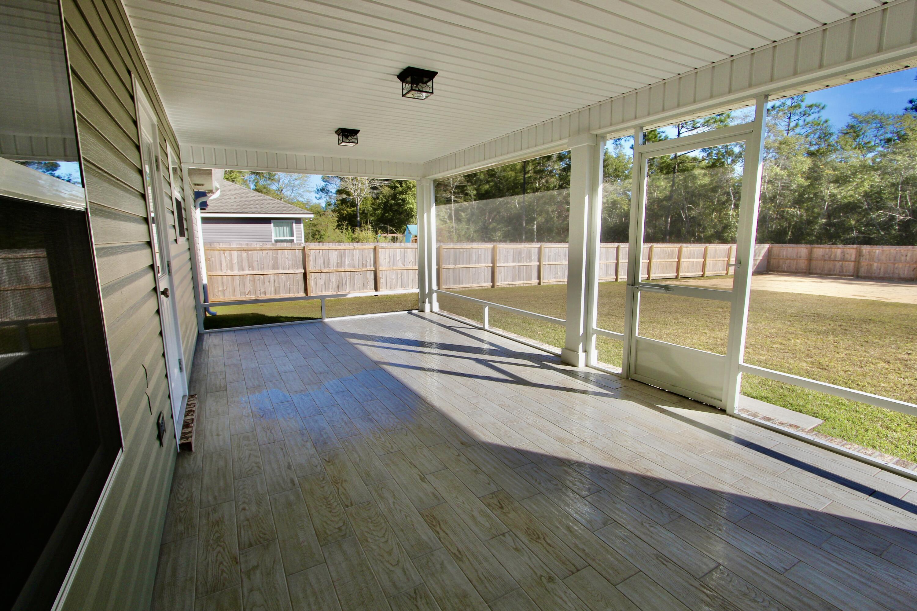 6447 Georgia Avenue Crestview, FL 32539 - Photo 29 of 36 a view of an empty room with a sliding door
