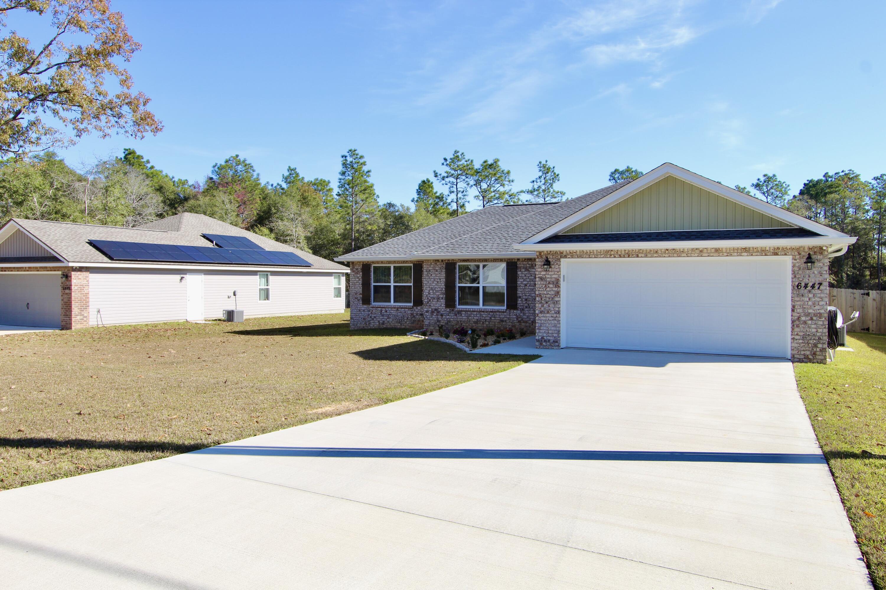 6447 Georgia Avenue Crestview, FL 32539 - Photo 3 of 36 a front view of a house with a yard