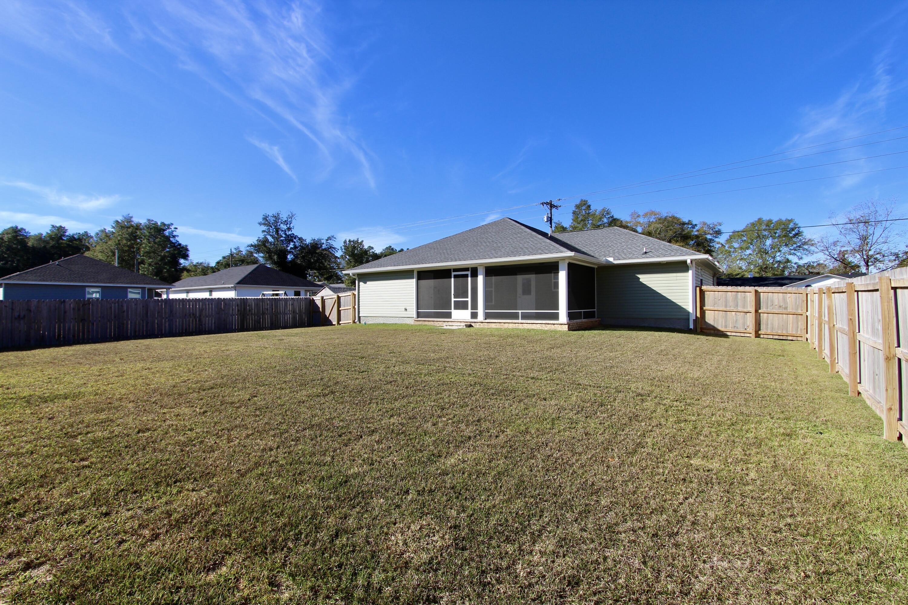 6447 Georgia Avenue Crestview, FL 32539 - Photo 33 of 36 a front view of a house with a yard