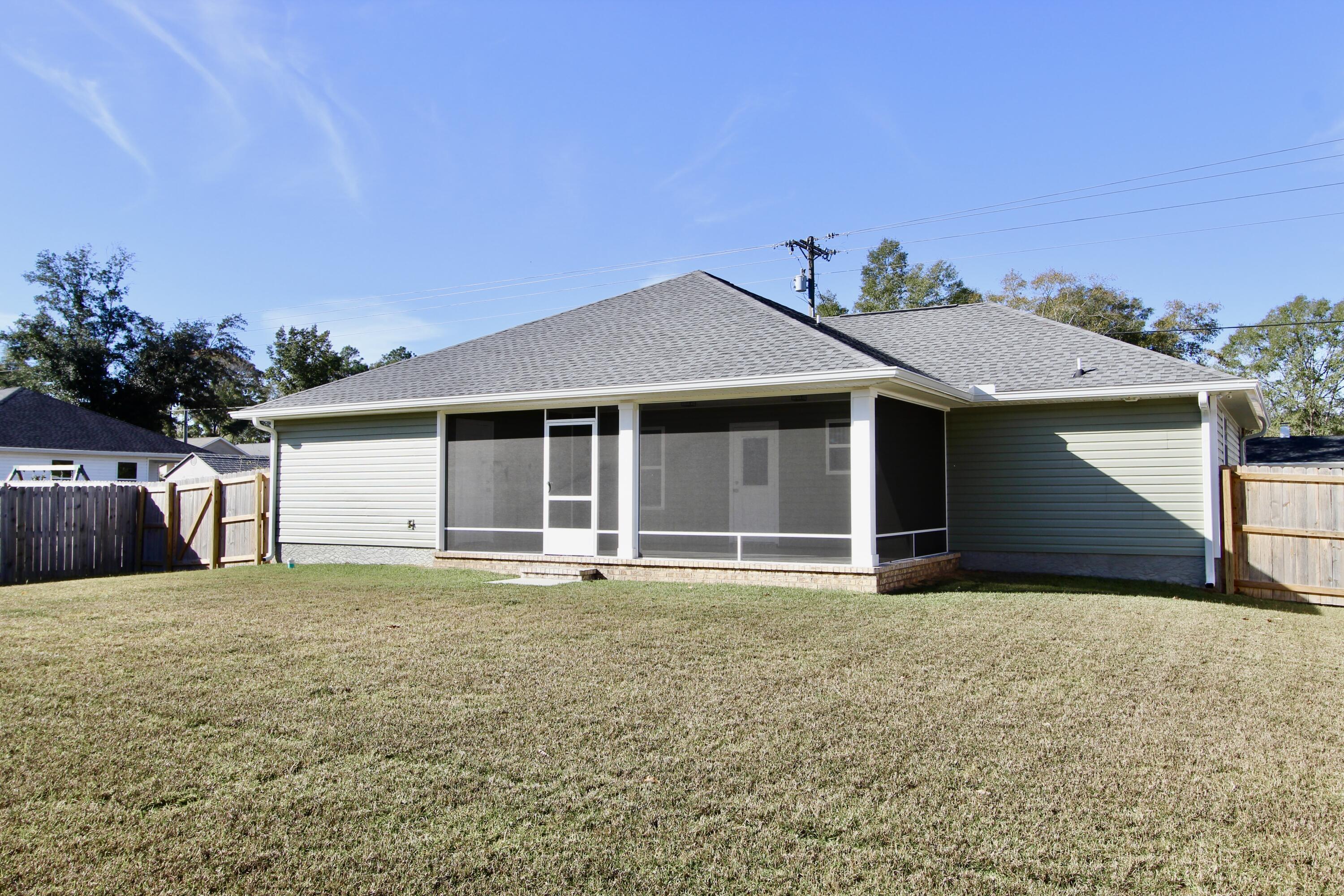 6447 Georgia Avenue Crestview, FL 32539 - Photo 35 of 36 a front view of a house with a yard