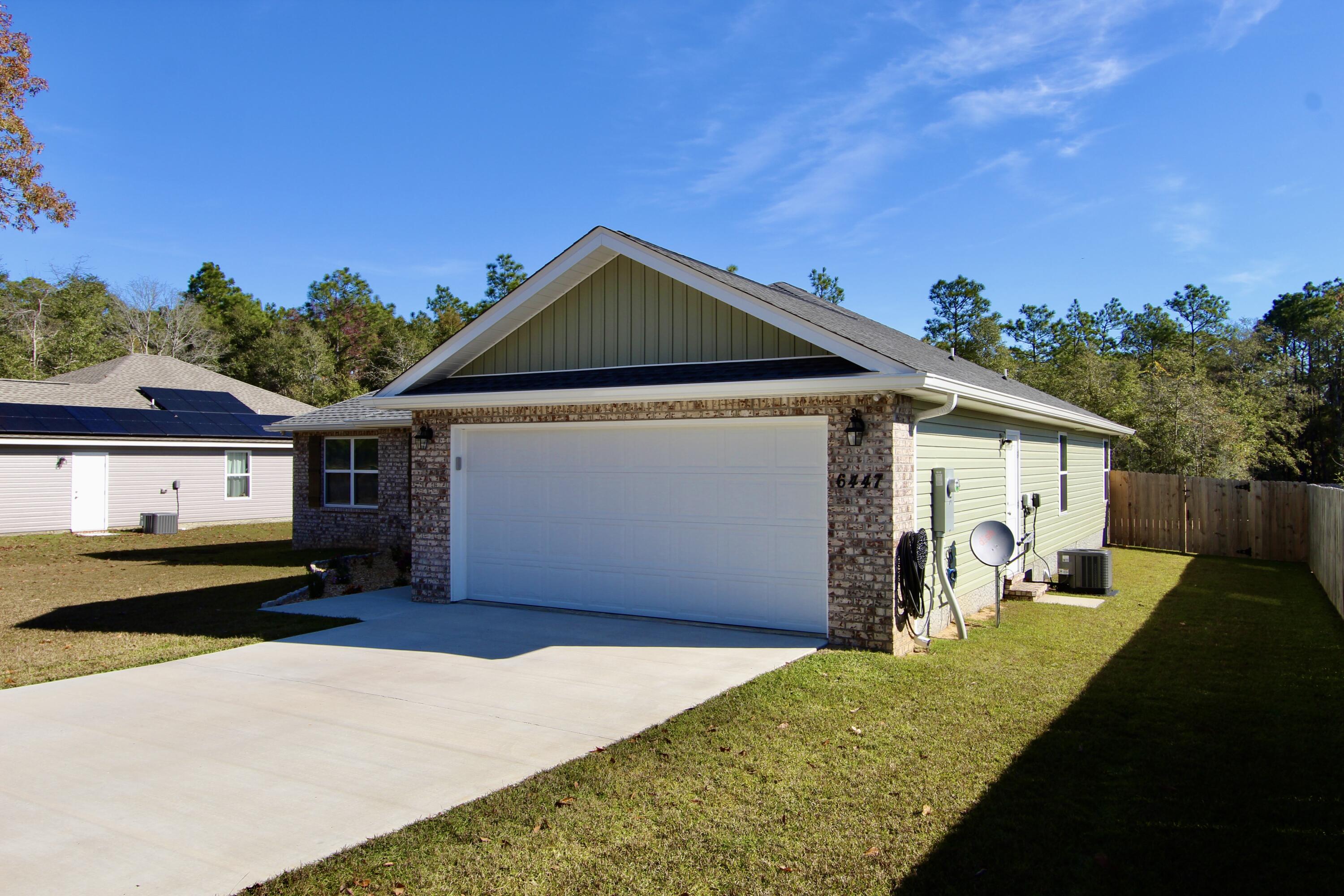6447 Georgia Avenue Crestview, FL 32539 - Photo 5 of 36 a front view of a house with a yard and garage
