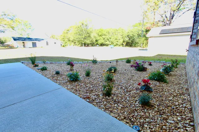 a white bath tub sitting in front of a house