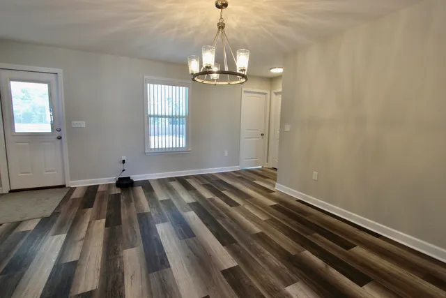 a kitchen with refrigerator and windows