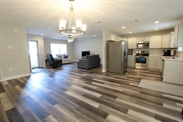a kitchen with stainless steel appliances a refrigerator sink and microwave