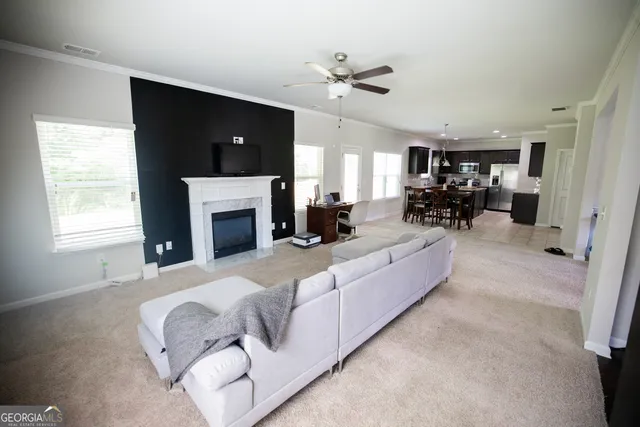 a living room with furniture fireplace and a flat screen tv