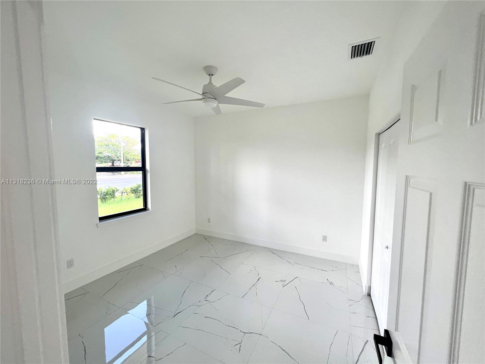 964 Rutherford Lane Haverhill, FL 33415 - Photo 14 of 18 a view of an empty room and window