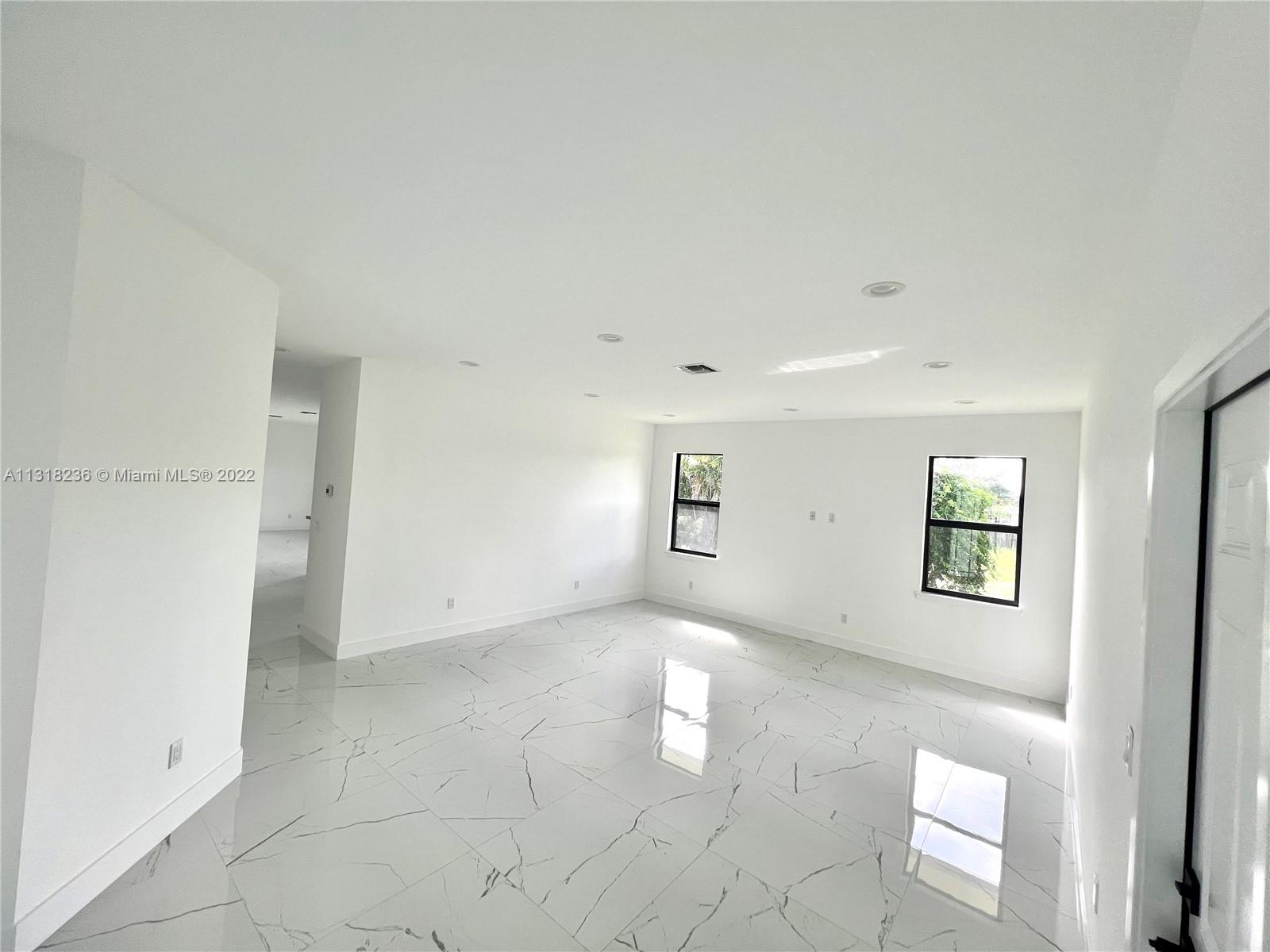 964 Rutherford Lane Haverhill, FL 33415 - Photo 18 of 18 an empty room with windows and entrance