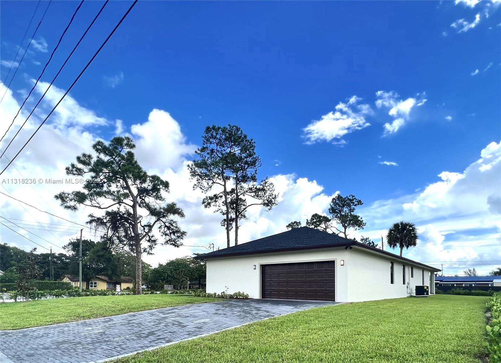 964 Rutherford Lane Haverhill, FL 33415 - Photo 3 of 18 a view of a house with a yard