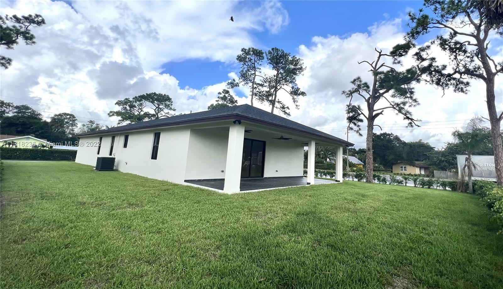 964 Rutherford Lane Haverhill, FL 33415 - Photo 5 of 18 a front view of a house with garden