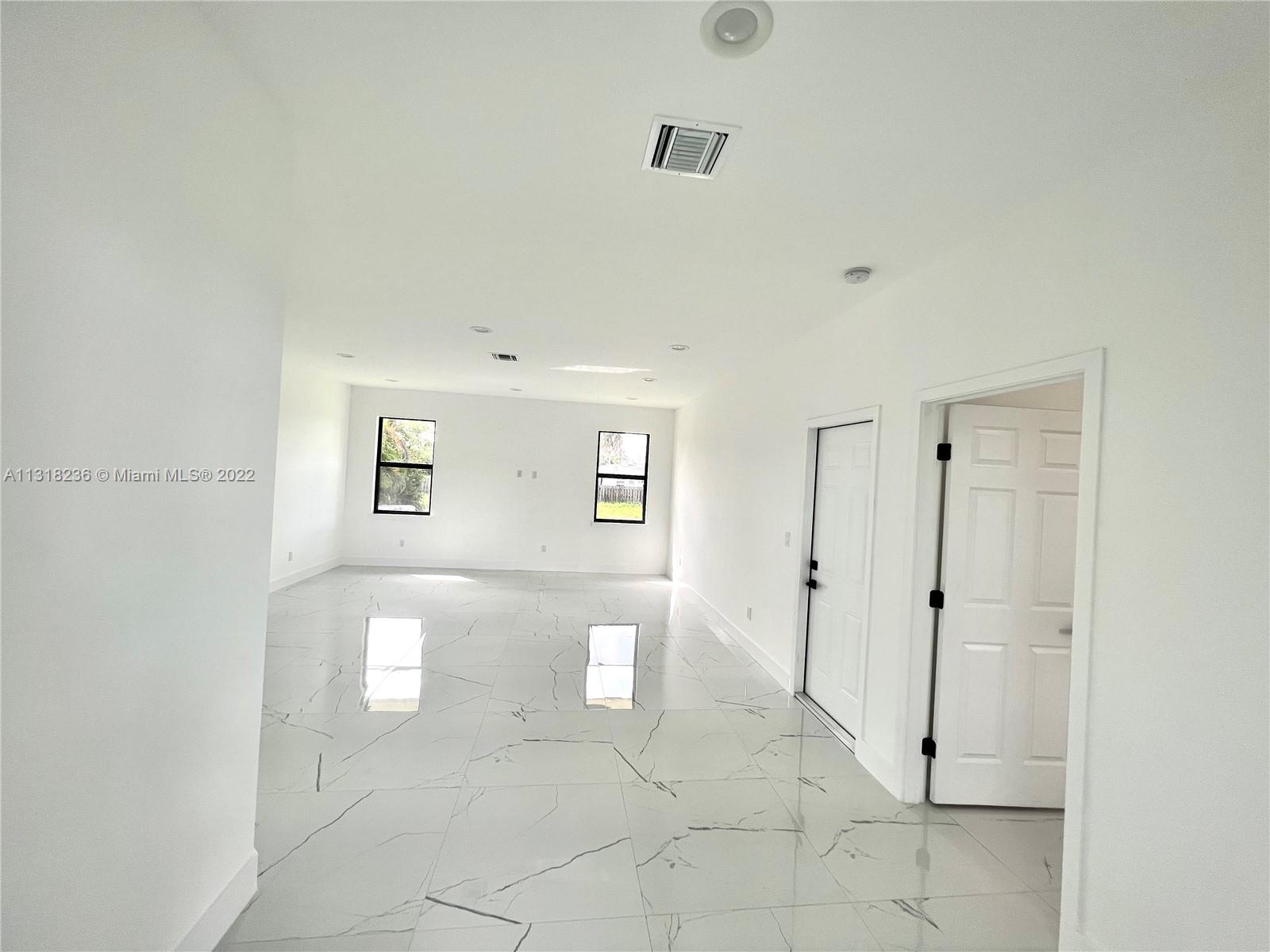 964 Rutherford Lane Haverhill, FL 33415 - Photo 7 of 18 a view of a livingroom with an empty space