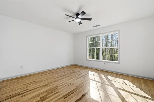 wooden floor in an empty room with a window