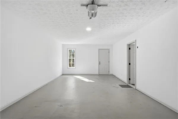 an empty room with a empty space and windows