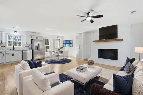 a living room with furniture kitchen view and a fireplace