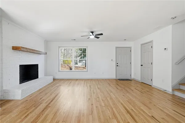 wooden floor in an empty room with a fireplace