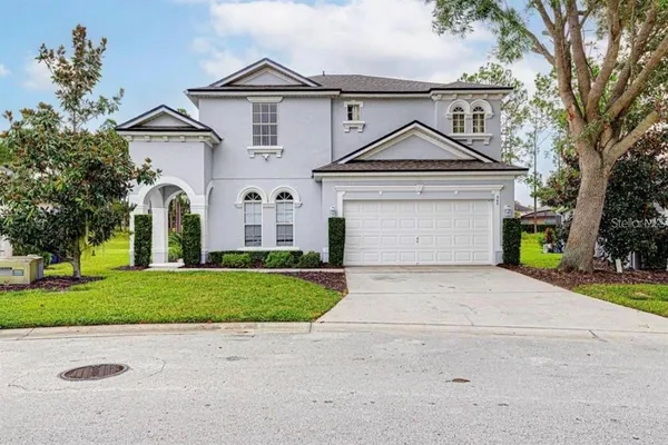 a front view of a house with a yard and garage