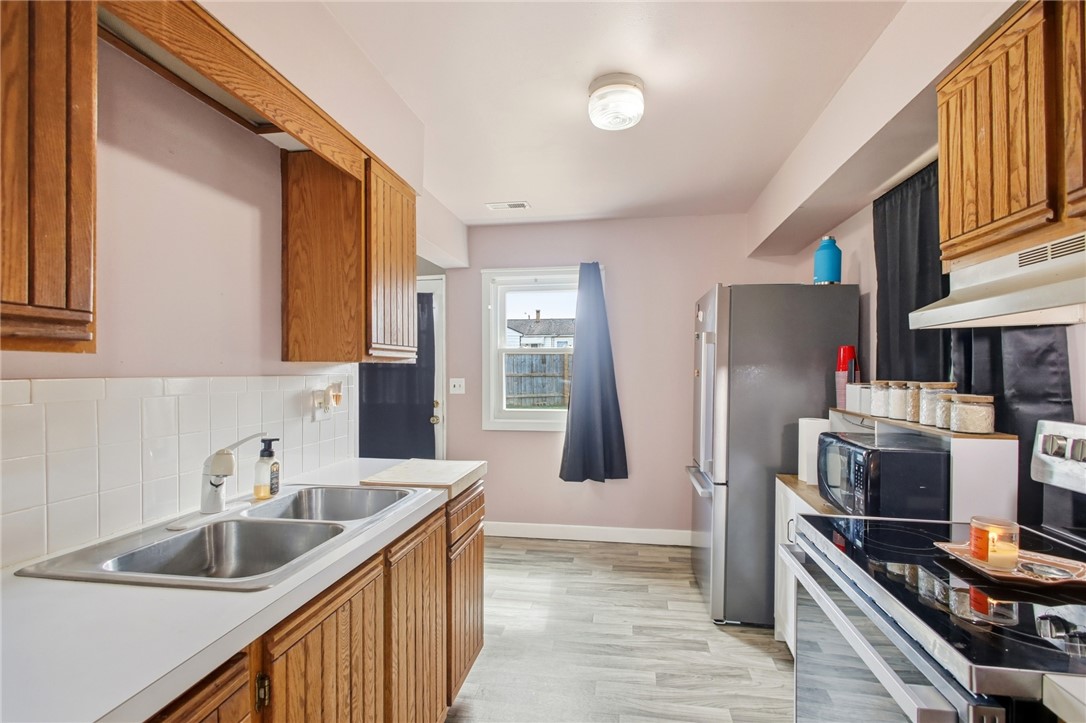 2745 Share Street Springfield, OH 45505 - Photo 8 of 28 This functional kitchen features a double basin sink and a contemporary stainless steel refrigerator.
