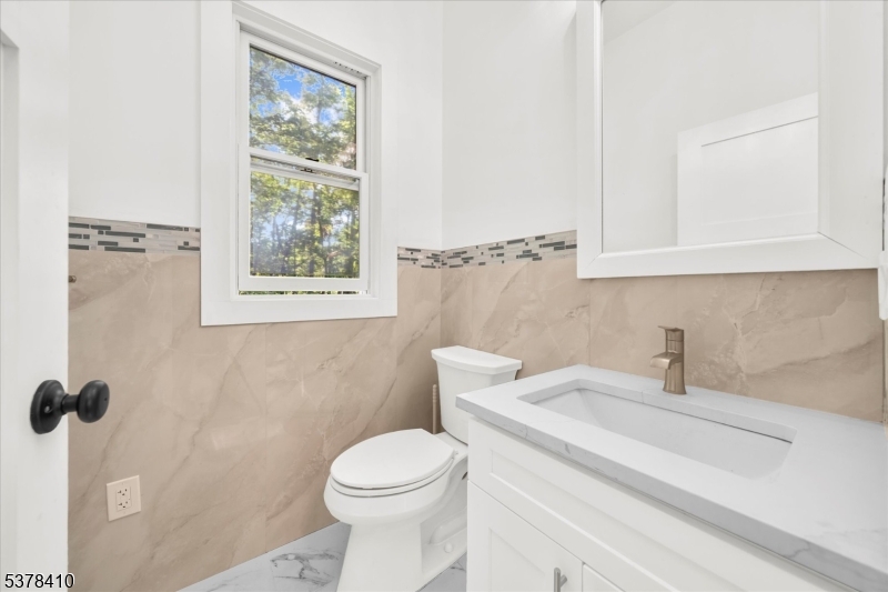 48 Norris Road Denville, NJ 07834 - Photo 12 of 33 a bathroom with a sink a toilet and a window