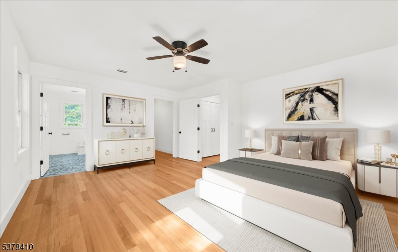48 Norris Road Denville, NJ 07834 - Photo 13 of 33 a spacious bedroom with a bed and a chandelier