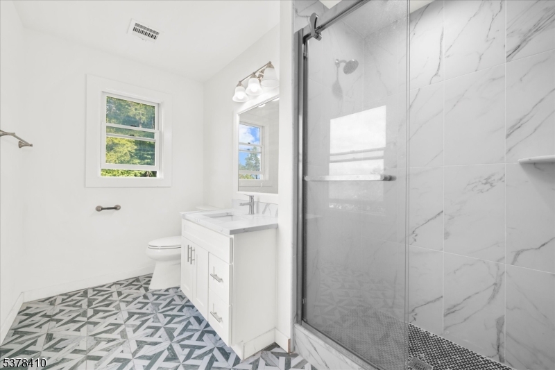 48 Norris Road Denville, NJ 07834 - Photo 15 of 33 a bathroom with a sink a toilet and shower
