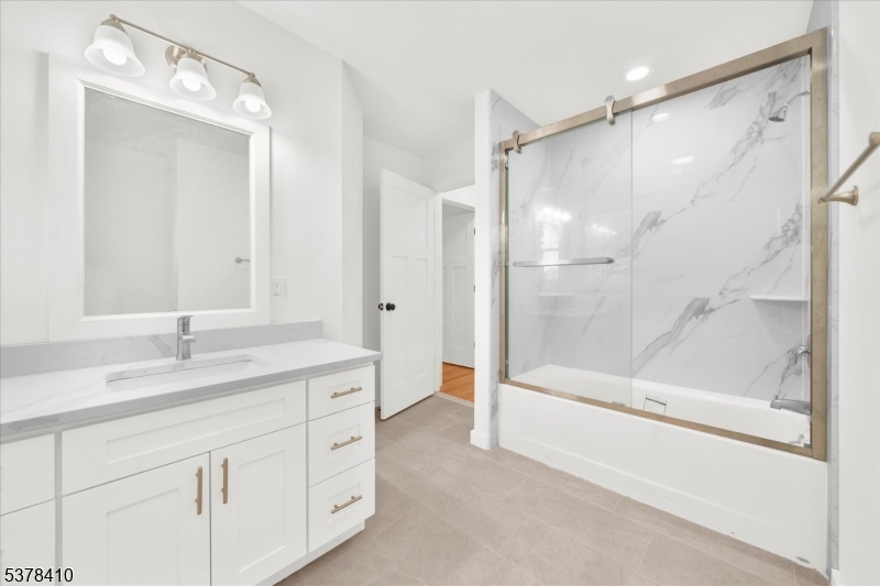 48 Norris Road Denville, NJ 07834 - Photo 18 of 33 a bathroom with a double vanity sink mirror double and shower