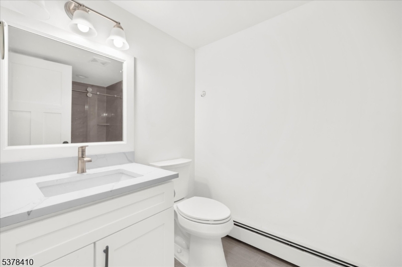 48 Norris Road Denville, NJ 07834 - Photo 25 of 33 a bathroom with a sink a toilet and mirror