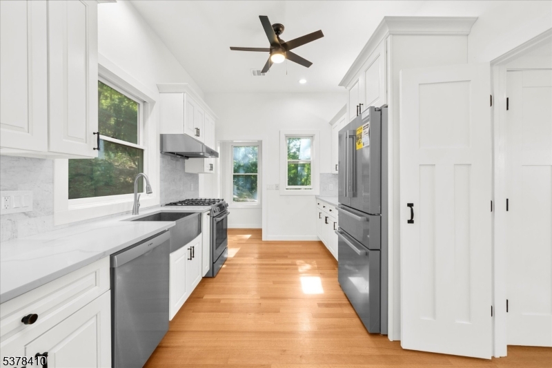 48 Norris Road Denville, NJ 07834 - Photo 9 of 33 a kitchen with stainless steel appliances a sink and a refrigerator