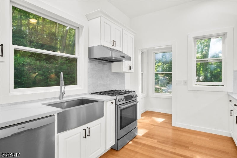 48 Norris Road Denville, NJ 07834 - Photo 10 of 33 a kitchen with a stove a sink and a wooden floor
