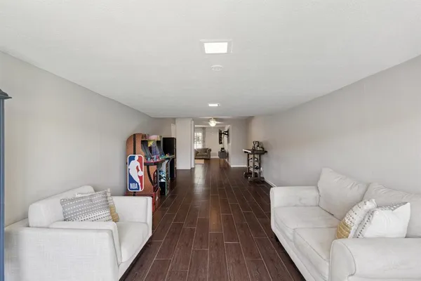 a living room with furniture and a wooden floor