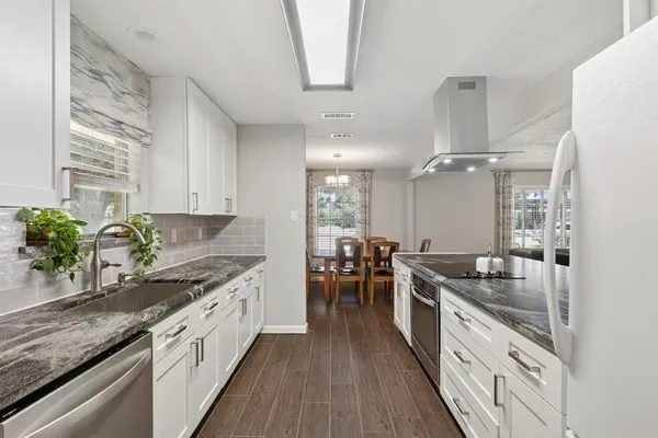a kitchen with granite countertop lots of counter top space and stainless steel appliances