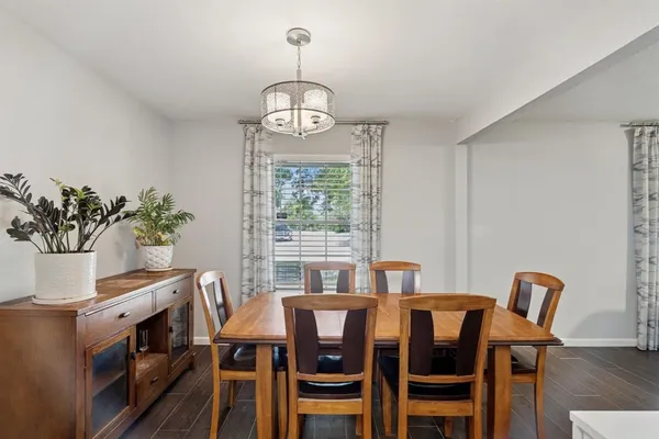 a view of a dining room with furniture window and wooden floor