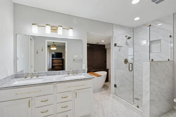 a bathroom with a granite countertop sink mirror and shower